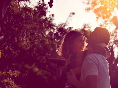 Romantic couple holidng together with sun light in evening.