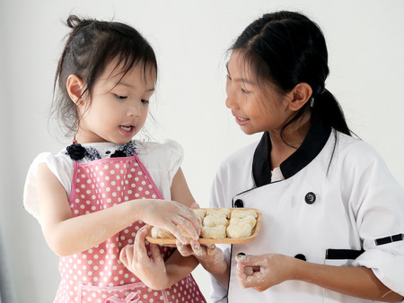 Girls showing her homemade bread or donut, lifestyle concept.