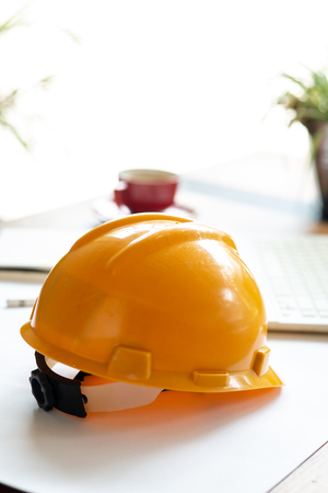 Yellow Engineer helmet on table.の写真素材