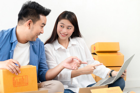 Asian couple with stack of parcel boxes, online business and delivery concept.の写真素材