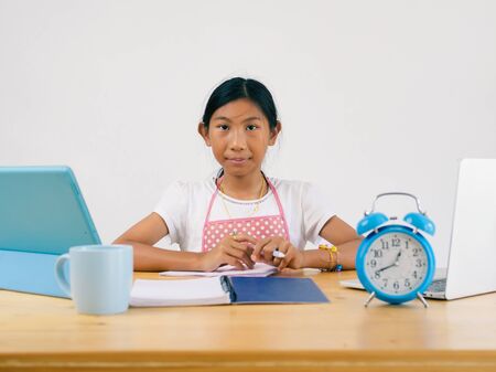 Happy Asian girl using laptop at home, technology concept.