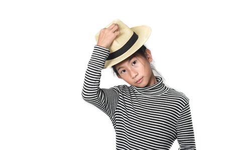 Happy Asian girl waering turtle neck and straw hat on white background.の写真素材