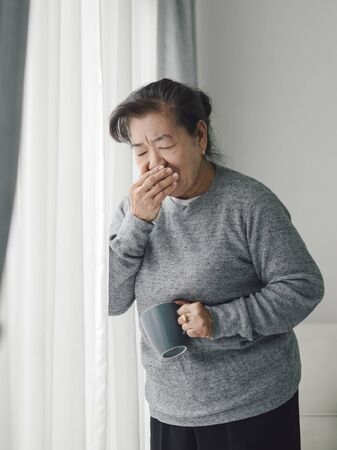 Asian senior woman have a cough at home, lifestyle concept.の写真素材