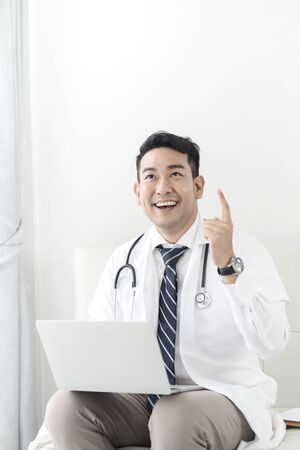 Asian doctor using laptop with idea lifestyle concept.の写真素材