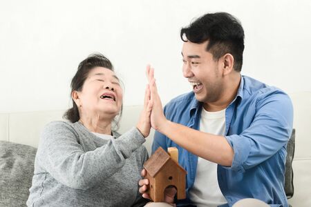 Asian man buy house for his mother, real estate concept.の写真素材