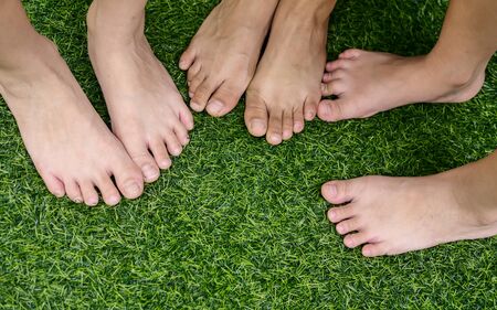Feets on green grass background.