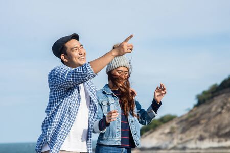 Asian couple enjoying nature view outdoor, lifestyle concept.の写真素材