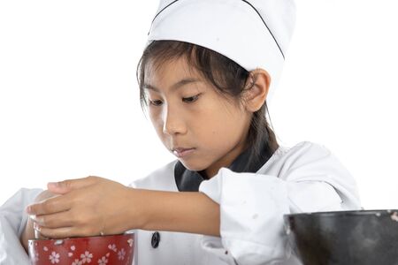 Asian girl learning how to making sushi on white backgroundの写真素材