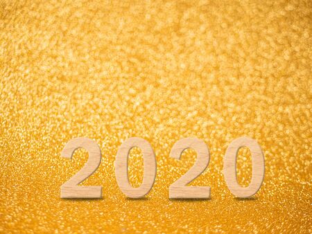 2020 on Abstract gold glitter bokeh lights. defocused lights background.