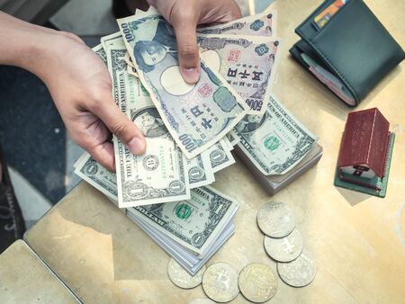 Rich businessman in real estate concept counting money in office.の写真素材