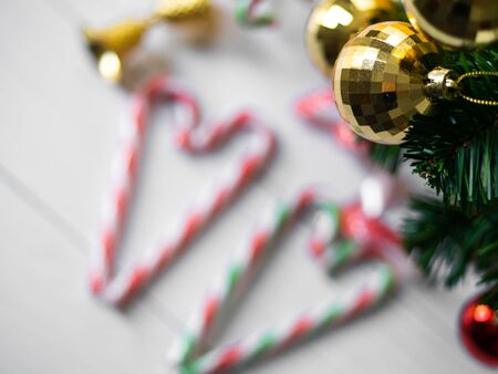 Heart shape christmas candy sticks and christmas tree on wooden table.の写真素材