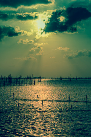 Sunset, the District North Island, North Lake Songkhla is putting family fishing nets.の写真素材
