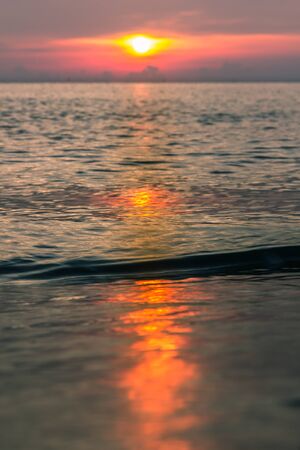 The rising sun, sea and beach.の写真素材