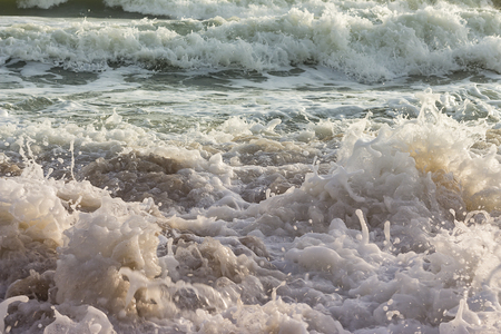 Waves and wind, the rain and the morning sunriseの写真素材