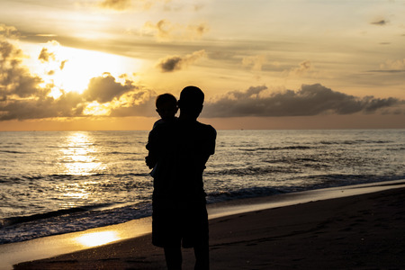 Father and son walking beach getawaysの写真素材