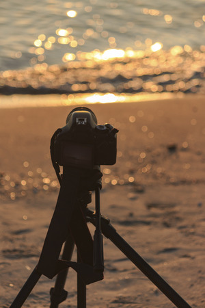 Camera on a tripod to take pictures of the sun and landscapeの写真素材