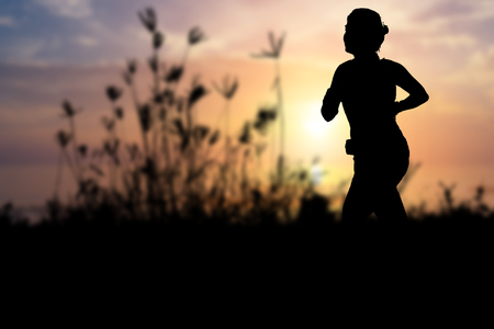 silhouette, running woman, nature and beautiful landscapeの写真素材