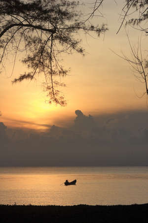 Boat silhouette, early morning, different perspectives, near and farの写真素材
