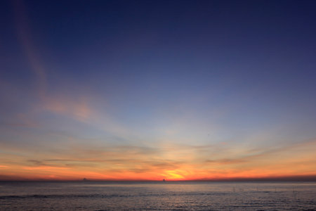 photograph of the sunrise from the sea and the beautiful sky and morning cloudsの写真素材