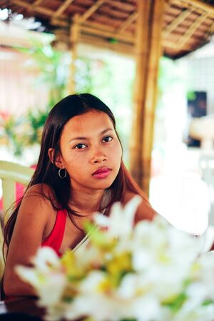 Beautiful young Asian girl chilling outside in the cottege
