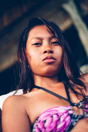 Portrait of beautiful young woman in swimsuit during summer on the beachの写真素材