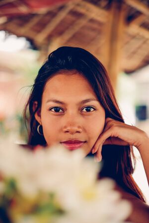 Beautiful young Asian girl chilling outside in the cottegeの写真素材