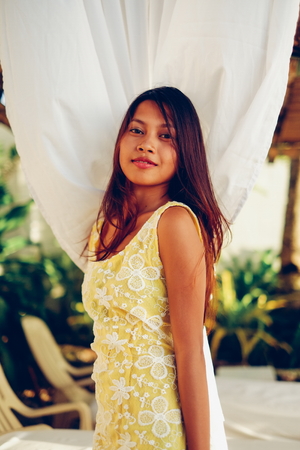 Beautiful Asian girl posing at the beach spaの写真素材