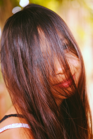 Natural portrait, Asian girl smiling with hair on her face. Native Asian beauty. Local Asian peopple