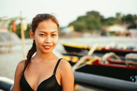 Beautiful native Asian girl on the beach, Girl during the summer on the local beach islandの写真素材