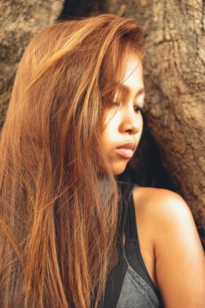 Beautiful Asian girl with beautiful brown long hair. Beautiful girl fashion