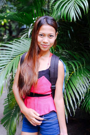 Beautiful girl backpaking in tropical rainforestの写真素材