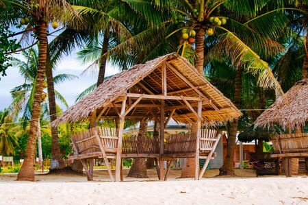 Summer sunshades and bamboo armchair on the tropical white sand beach,の写真素材