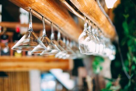 Hanging glasses in bar on the beach , shallow focusの写真素材