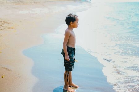 Happy portrait of one little girl on the beachの写真素材
