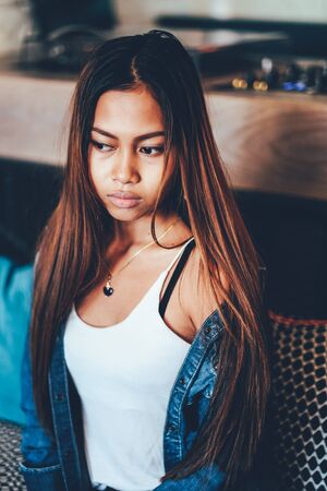 Gorgeous young woman in blue jeans chilling in a barの写真素材