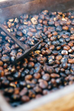 Roasting chestnut on street in the charcoal burnerの写真素材