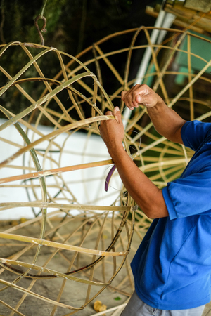 Man making object from bamboo by handの写真素材