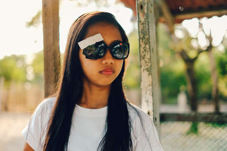 Young beautiful Asian girl with sunglasses