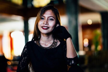 Portrait of beautiful elegant young lady with nice background lightの写真素材