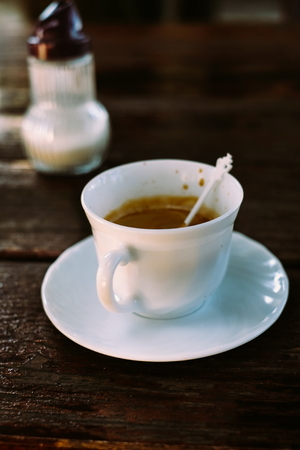 Tasty Coffee Espresso in a white Cup on a Wooden Backgroundの写真素材