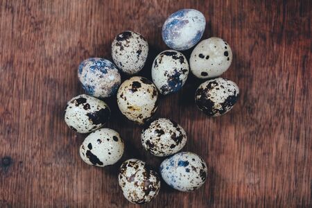 many quail eggs. quail eggs on the brown table. quail eggs on wooden background