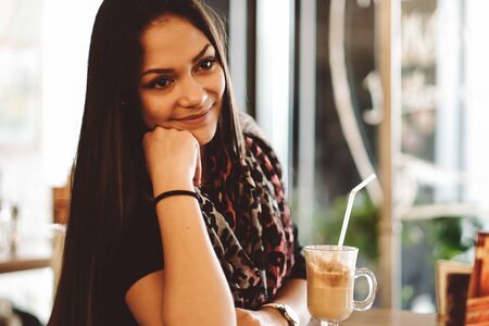 Beautiful girl drinking ice moca shake in a cafeの写真素材