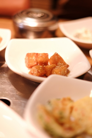 A traditional Korean restaurant with various side dishes. Korean meal side dishes of vegetable kinchi groundnuts garlic bean sprout seaweedの写真素材