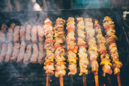 Grilling chicken meat skewers and skebab with vegetables on barbeque charcoal grillの写真素材