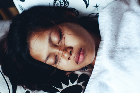 Young Asian woman sleeping peacefully in the bacony during summer vacation