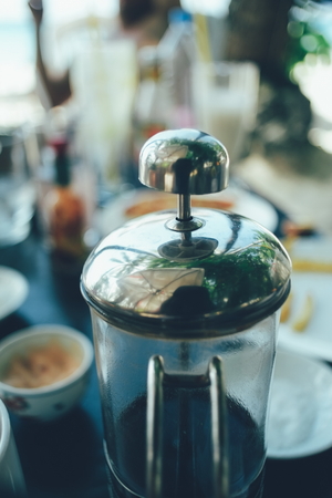 French press coffee maker in a cafe bar. close up image toned image selective focusの写真素材