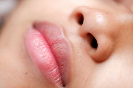 Young Asian woman closeup face sleeping during the dayの写真素材