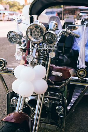 Beautiful wedding concept big trike, motorbike decorated with balloons and ribbonの写真素材