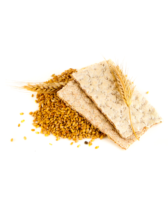 grain crackers, biscuits and grains of wheat on white backgroundの写真素材