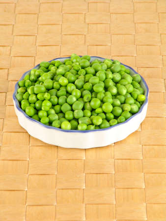 fresh green peas in the pod on brown backgroundの写真素材